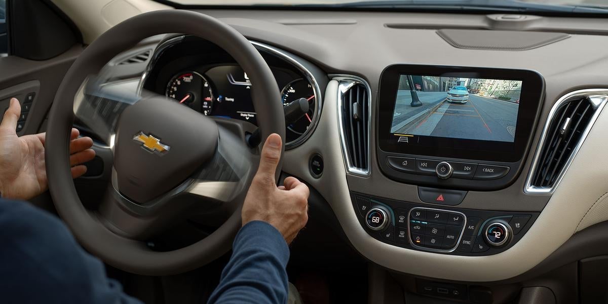 Persons hands are on stairing and back view is visible on screen